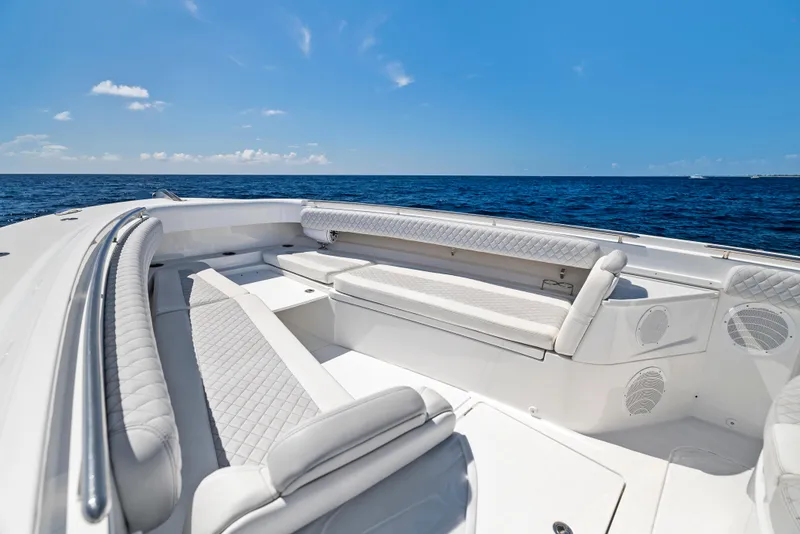 Slide: The Image of 2022 HCB Suenos boat interior with luxurious seating, ocean view, and clear blue sky. - 4