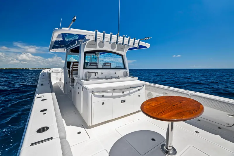 Slide: The Image of 2022 HCB Suenos boat with sleek deck and ocean backdrop. - 47