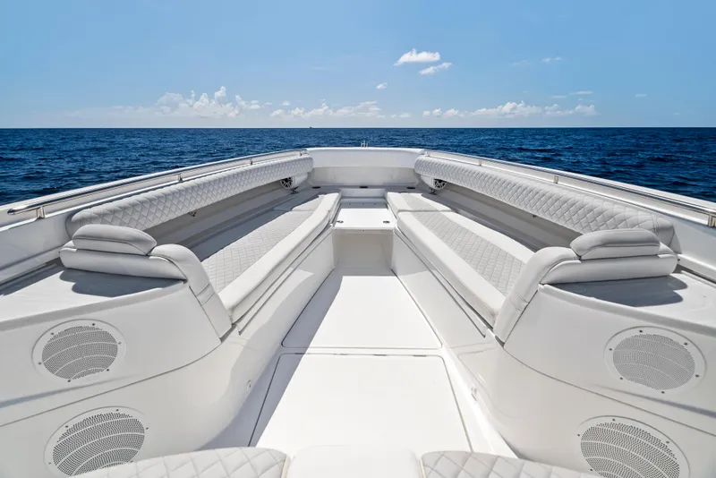 Slide: The Image of 2022 HCB Suenos boat interior with luxurious seating, set against a serene ocean backdrop. - 5