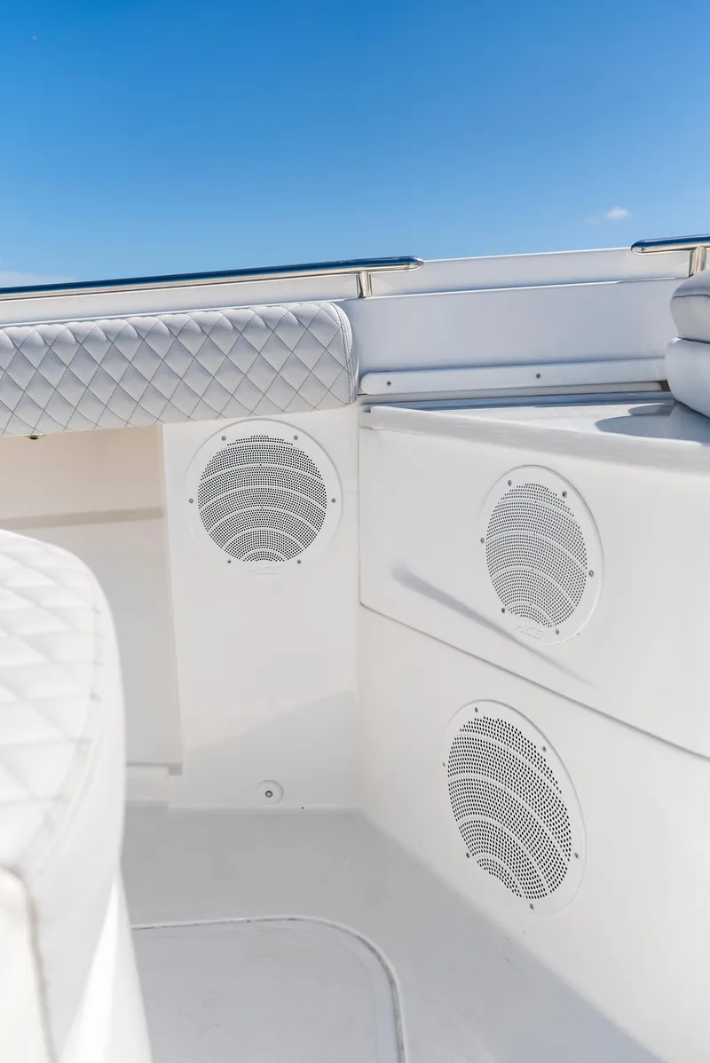Slide: The Image of 2022 HCB Suenos boat interior with white seating and built-in speakers. - 6