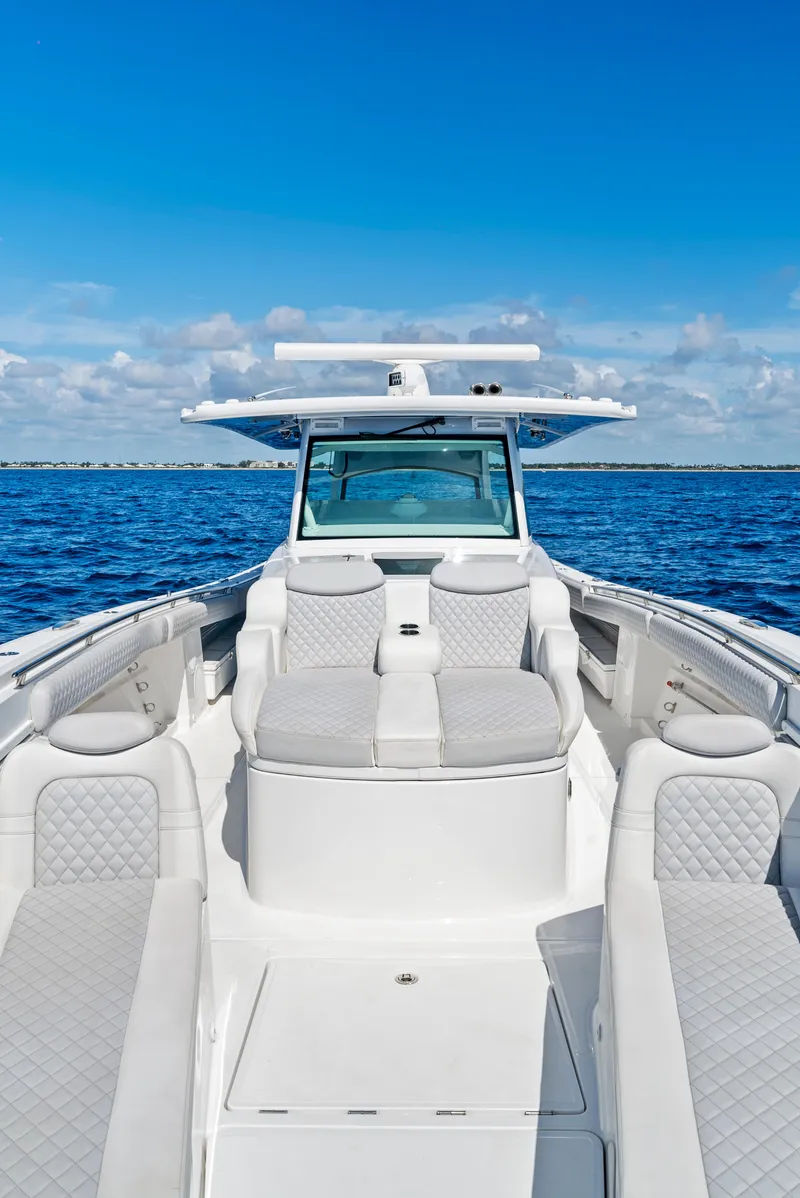 Slide: The Image of 2022 HCB Suenos boat on open water, featuring luxurious seating and sleek design. - 9