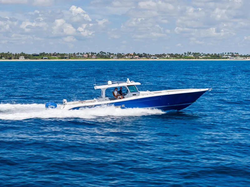 The Image of 2022 HCB Suenos boat cruising on blue ocean under a partly cloudy sky. - 0