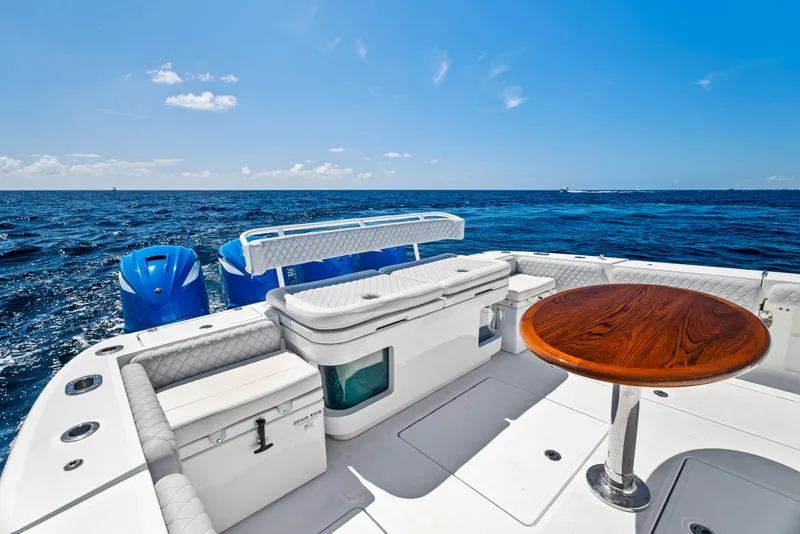 Slide: The Image of 2022 HCB Suenos boat deck with seating and table, overlooking the ocean. - 11