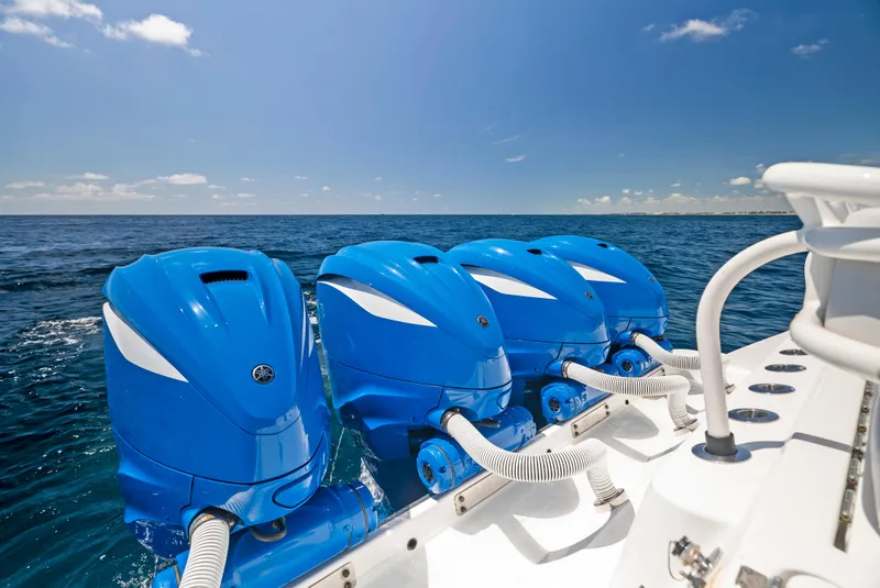 Slide: The Image of Four blue outboard motors on a 2022 HCB Suenos boat in open sea. - 31