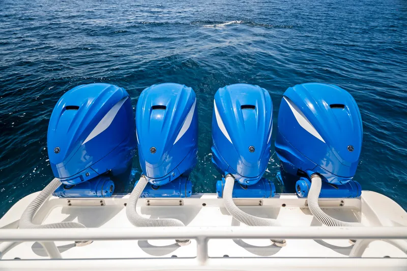 Slide: The Image of Four blue outboard motors on a 2022 HCB Suenos boat. - 32