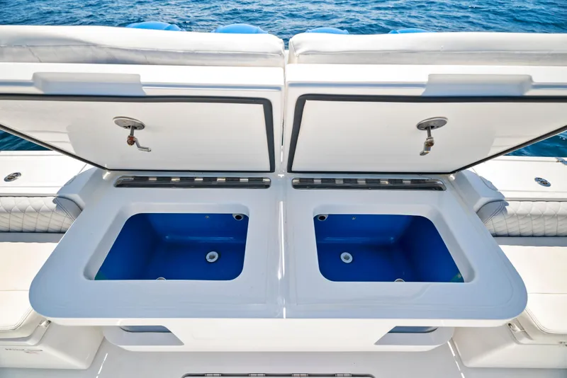 Slide: The Image of 2022 HCB Suenos boat with open dual storage compartments on deck. - 36