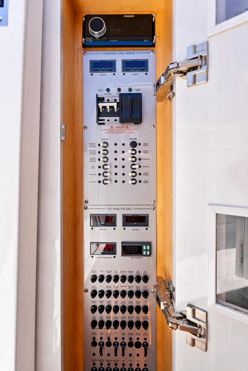 Slide: The Image of Electrical control panel inside 2022 HCB Suenos boat, featuring switches and gauges. - 42