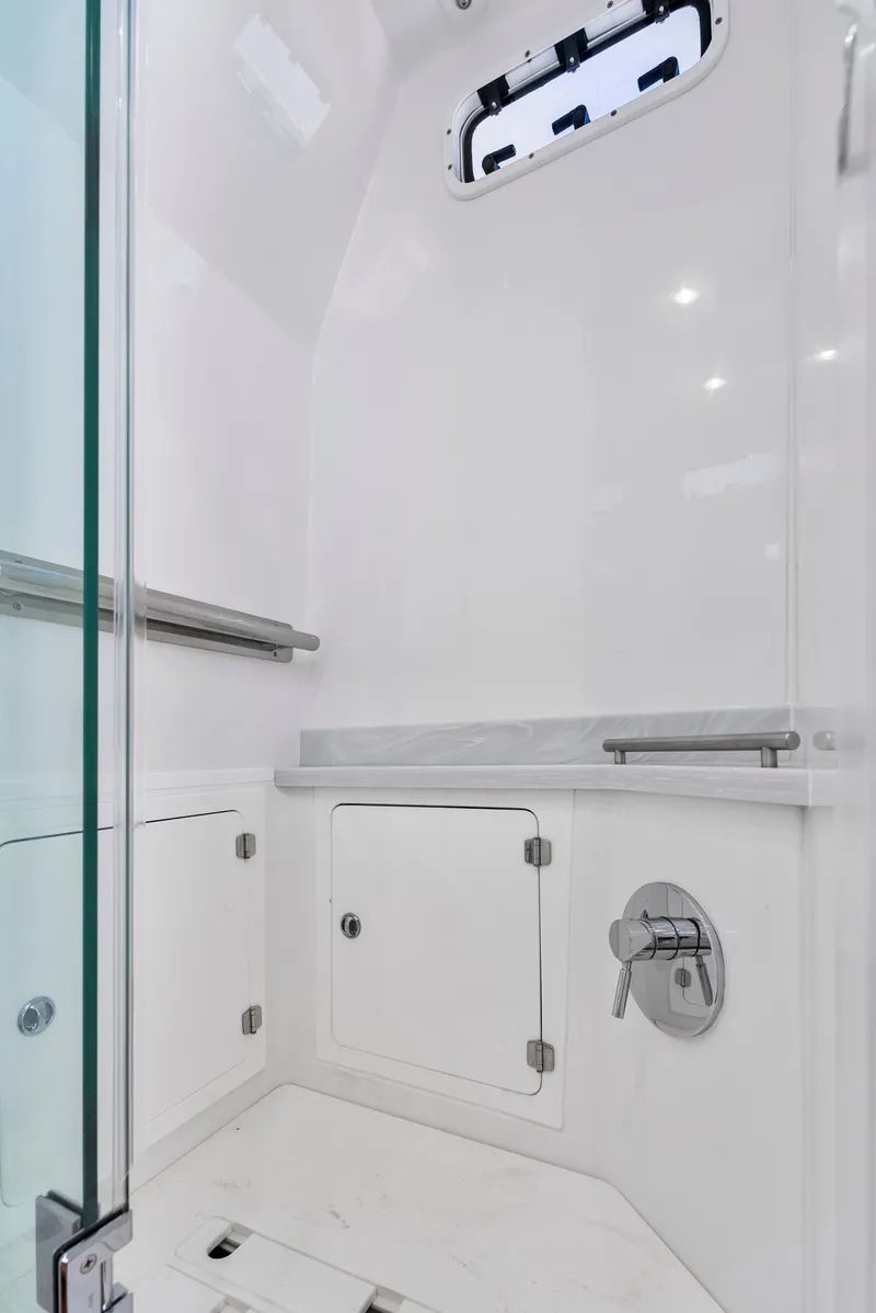 Slide: The Image of 2022 HCB Suenos boat interior shower with sleek white design and modern fixtures. - 44