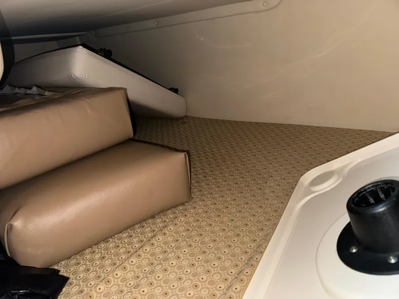 Slide: The Image of Interior cabin of 2011 Glastron GS 289 boat with beige cushions and patterned flooring. - 49