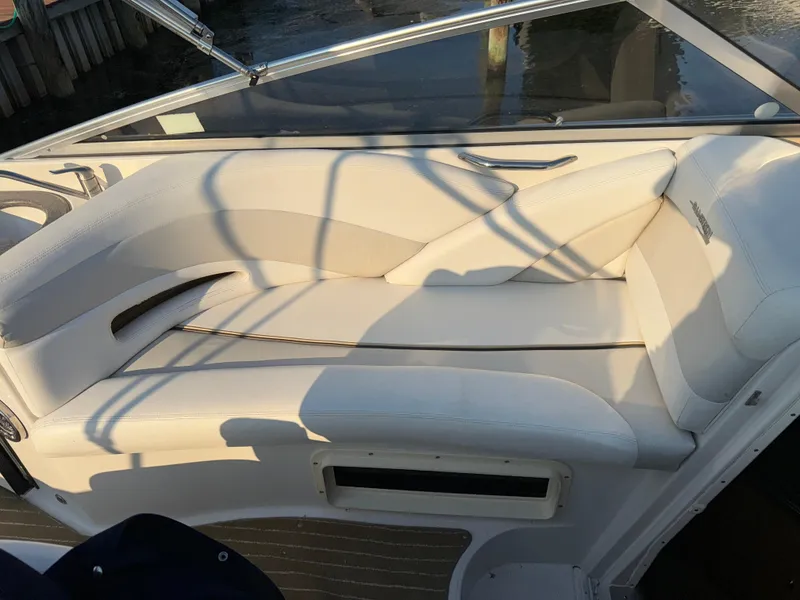 Slide: The Image of 2011 Glastron GS 289 boat interior with white cushioned seating. - 20