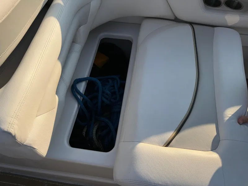Slide: The Image of 2011 Glastron GS 289 boat seat storage compartment with rope inside. - 21