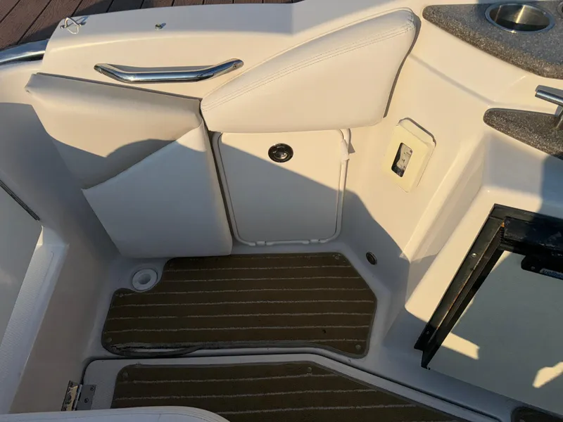 Slide: The Image of Interior of 2011 Glastron GS 289 boat, featuring seating and storage compartments. - 22