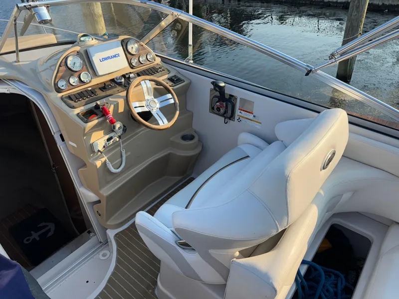 Slide: The Image of 2011 Glastron GS 289 boat cockpit with steering wheel and navigation system. - 23