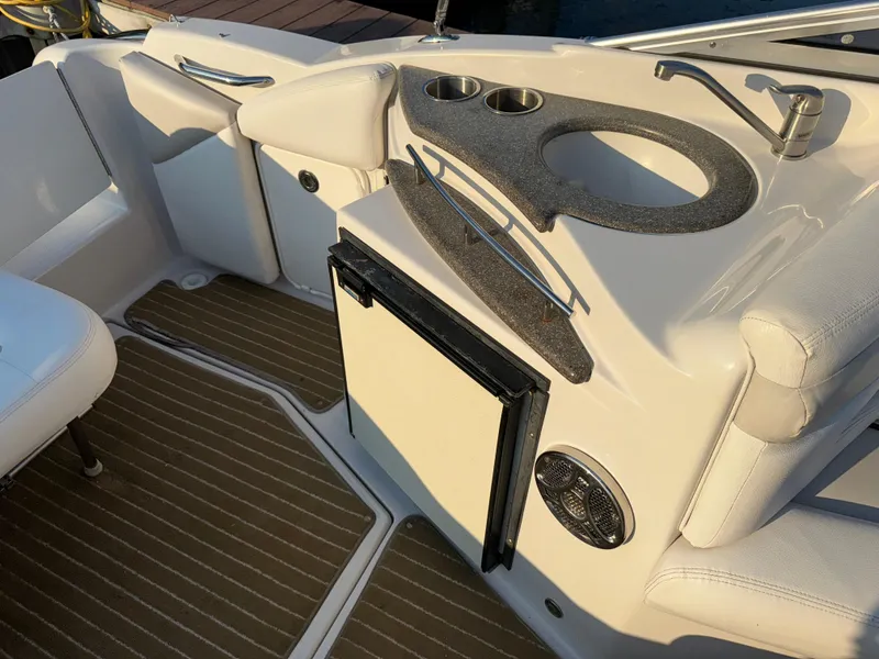 Slide: The Image of 2011 Glastron GS 289 boat interior with kitchenette and seating area. - 27