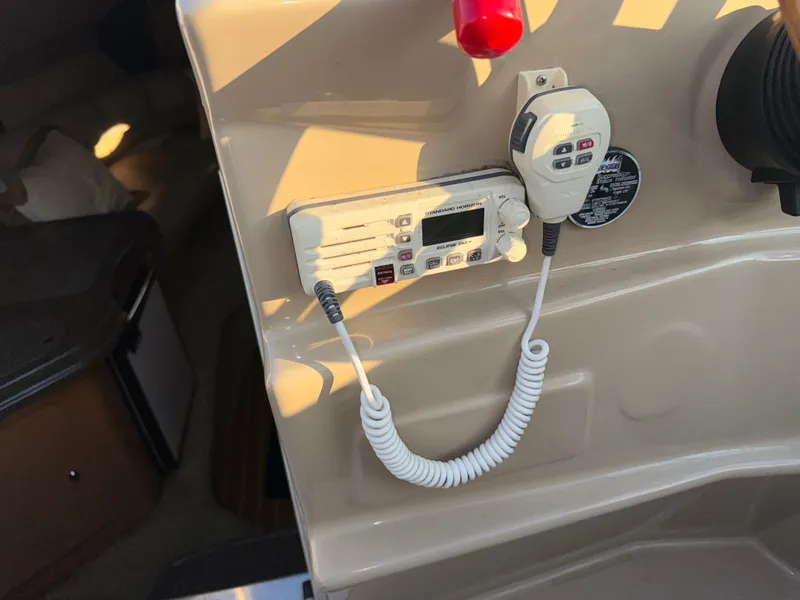 Slide: The Image of 2011 Glastron GS 289 boat interior with radio and microphone setup. - 29