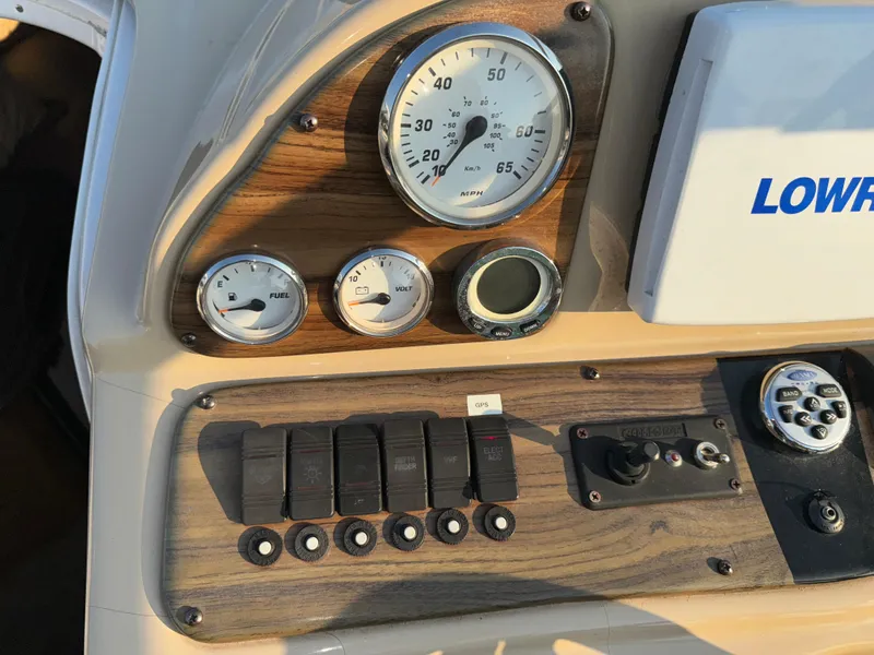 Slide: The Image of Dashboard of 2011 Glastron GS 289 boat with gauges and controls. - 31