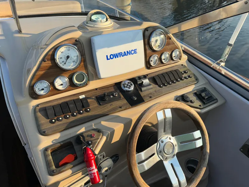Slide: The Image of 2011 Glastron GS 289 boat dashboard with Lowrance navigation system and gauges. - 32
