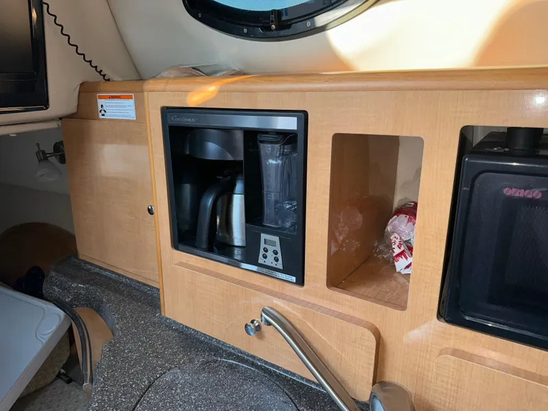 Slide: The Image of 2011 Glastron GS 289 boat interior with kitchenette and appliances. - 41