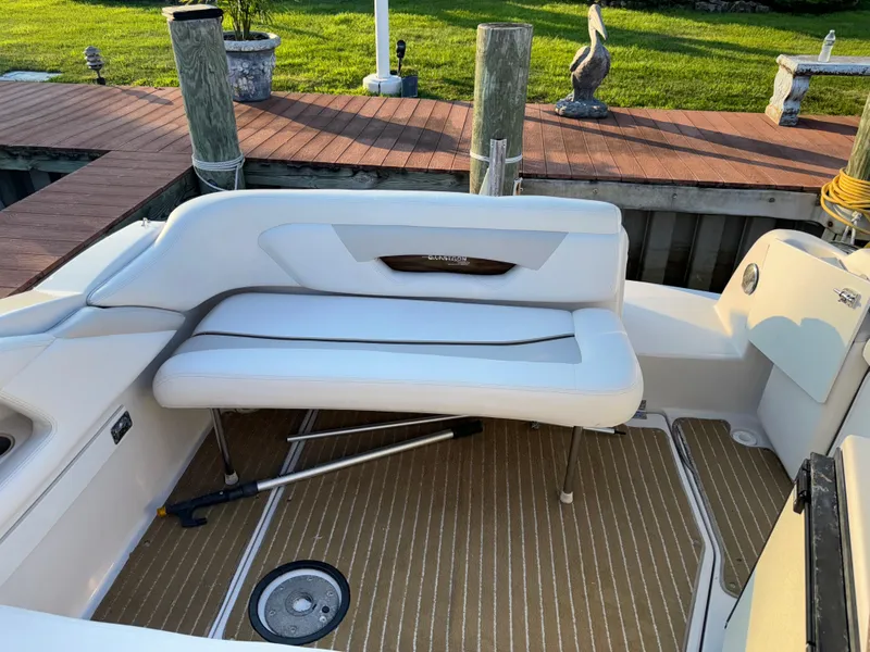 Slide: The Image of 2011 Glastron GS 289 boat interior with white seating and wooden deck. - 16