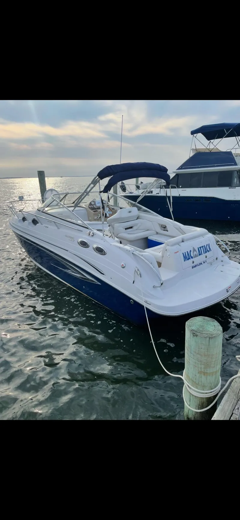 The Image of 2011 Glastron GS 289 boat docked on calm water. - 2