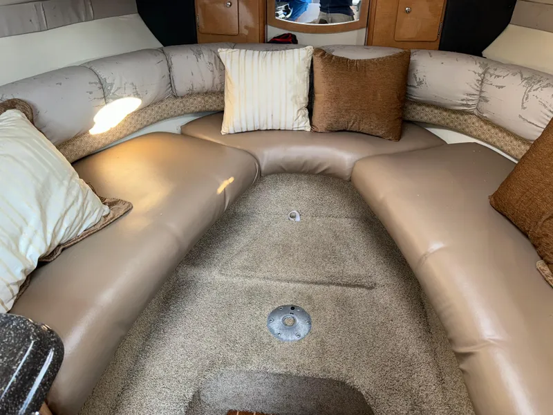 Slide: The Image of 2011 Glastron GS 289 cabin interior with beige seating and cushions. - 34