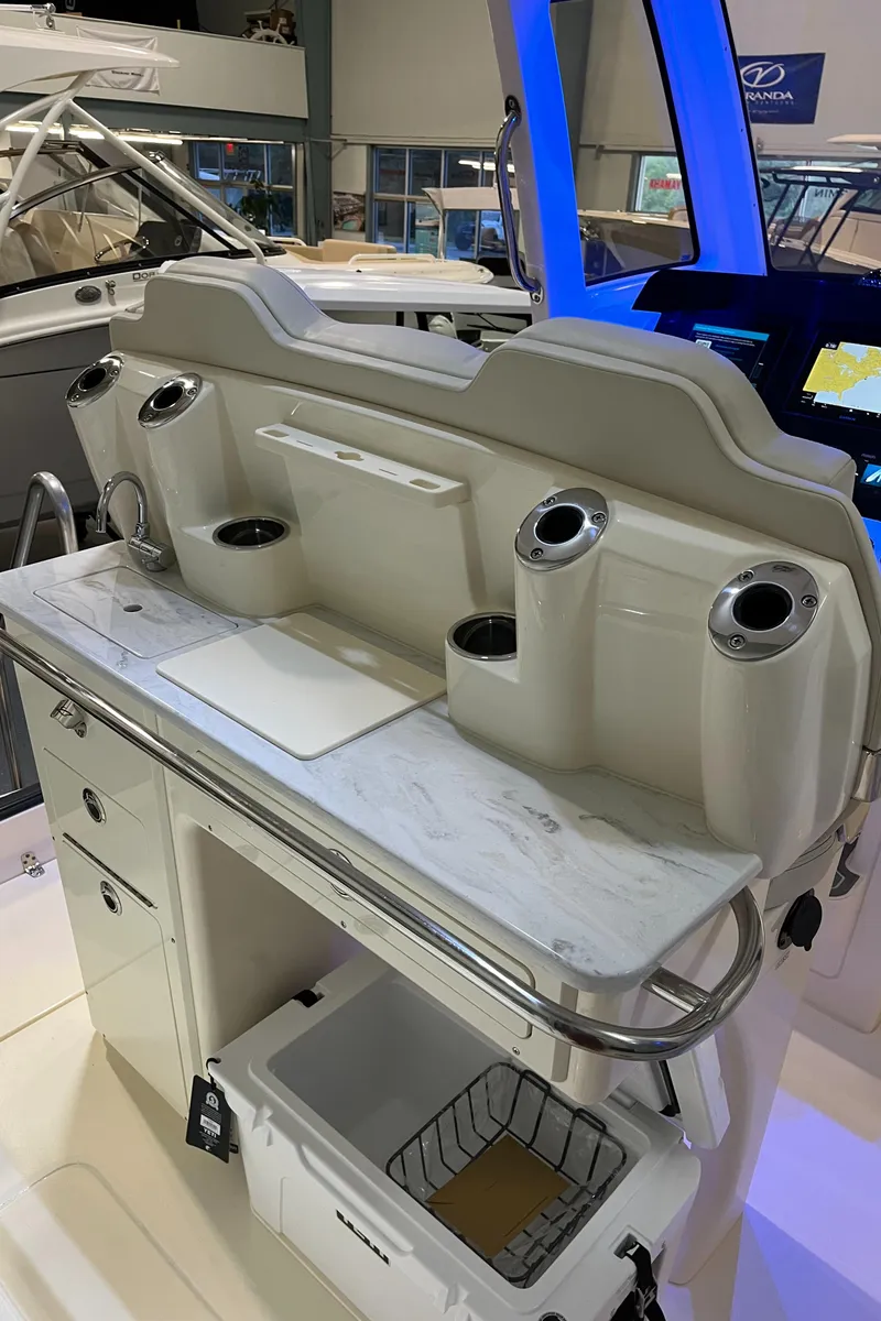 Slide: The Image of 2025 Scout 260 LXF boat interior with fishing rod holders and storage compartments. - 13