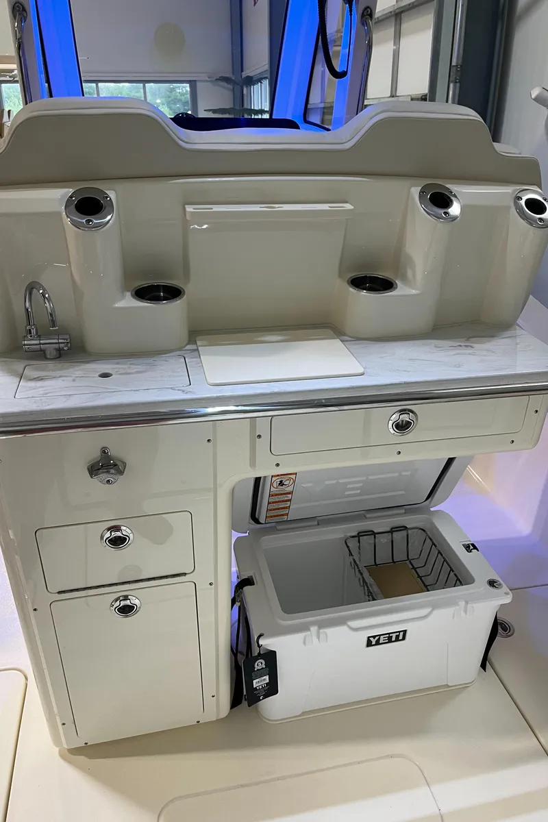 Slide: The Image of 2025 Scout 260 LXF boat interior with Yeti cooler and storage compartments. - 14