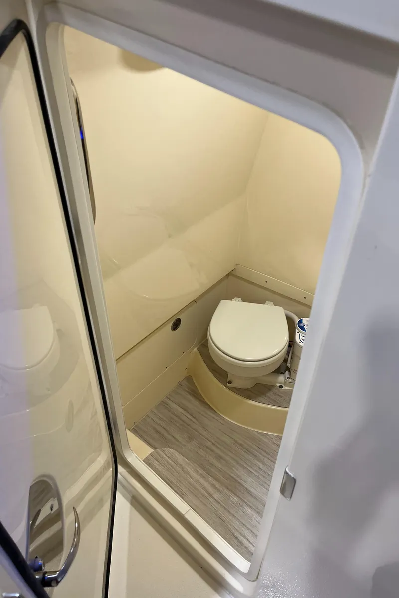 Slide: The Image of 2025 Scout 260 LXF boat interior bathroom with toilet. - 17
