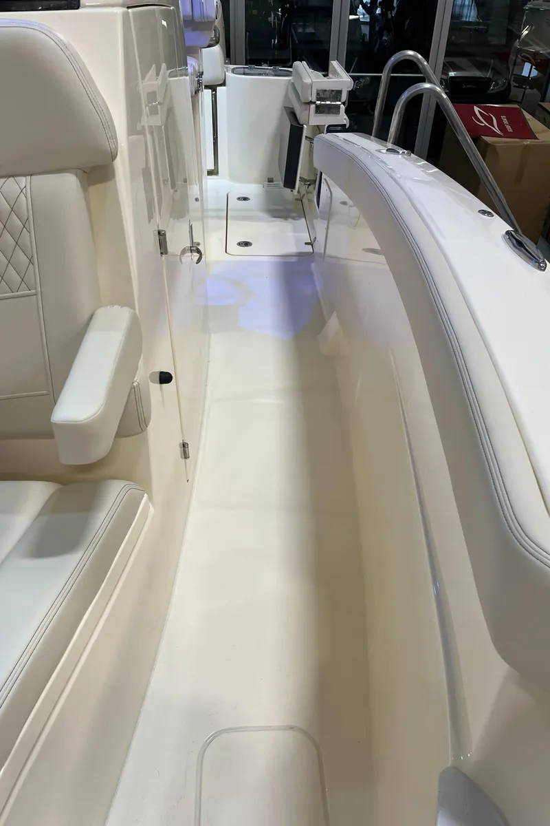 Slide: The Image of 2025 Scout 260 LXF boat interior with white seating and sleek design. - 21