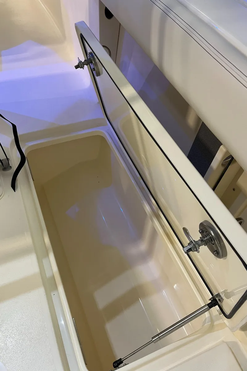 Slide: The Image of 2025 Scout 260 LXF boat storage compartment with open lid. - 22