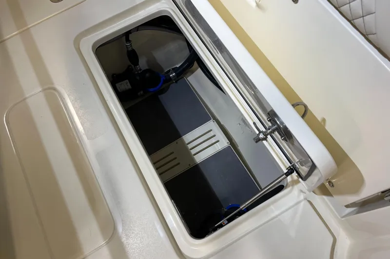 Slide: The Image of 2025 Scout 260 LXF boat storage compartment with open hatch. - 23