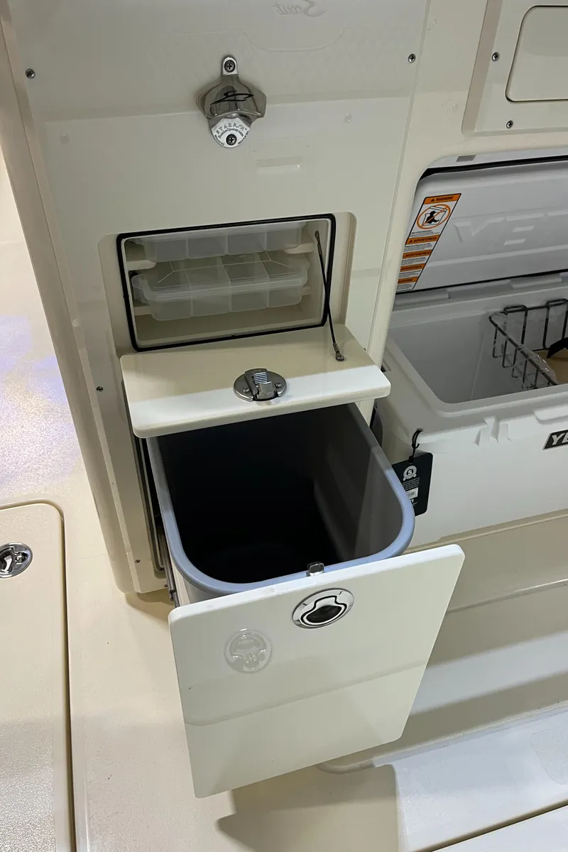 Slide: The Image of 2025 Scout 260 LXF boat with built-in ice maker and storage compartment. - 24