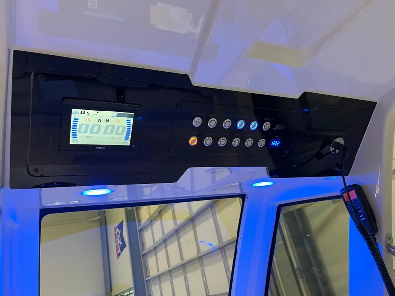 Slide: The Image of 2025 Scout 260 LXF boat dashboard with digital display and control panel. - 5