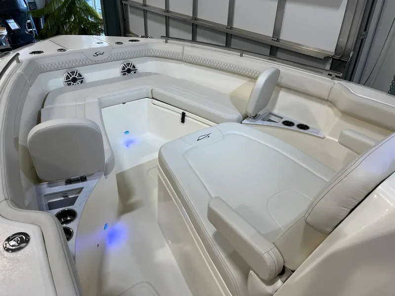 Slide: The Image of 2025 Scout 260 LXF boat interior with white seating and blue LED lights. - 7