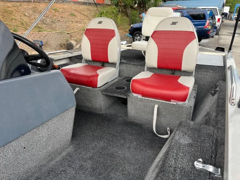 Slide: The Image of 1990 Bass Tracker Pro 17 boat interior with red and white seats. - 10
