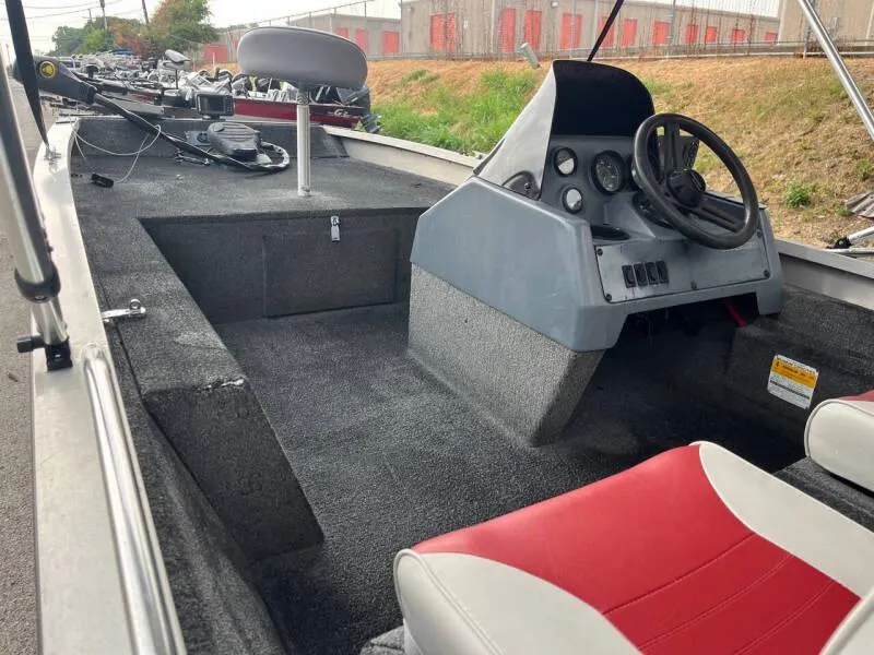Slide: The Image of 1990 Bass Tracker Pro 17 boat interior with steering console and seating. - 11