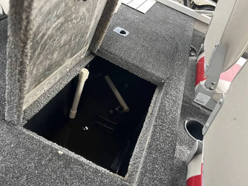 Slide: The Image of 1990 Bass Tracker Pro 17 boat storage compartment with open hatch. - 13