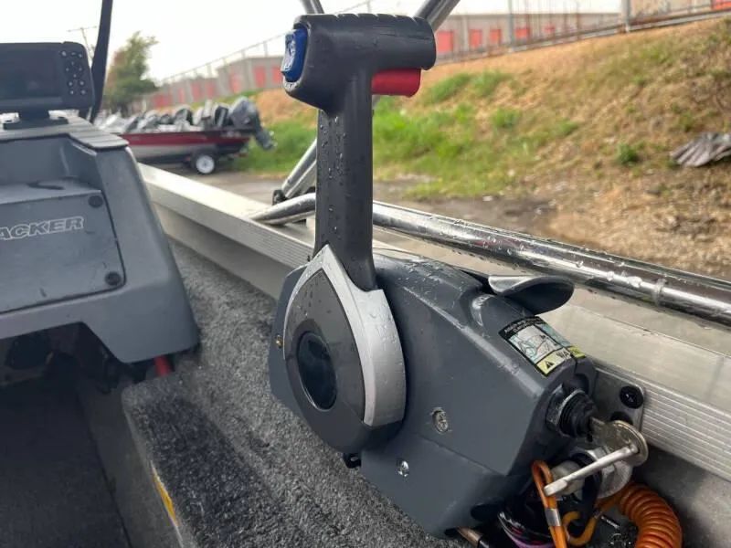 Slide: The Image of 1990 Bass Tracker Pro 17 boat throttle control in cockpit. - 14