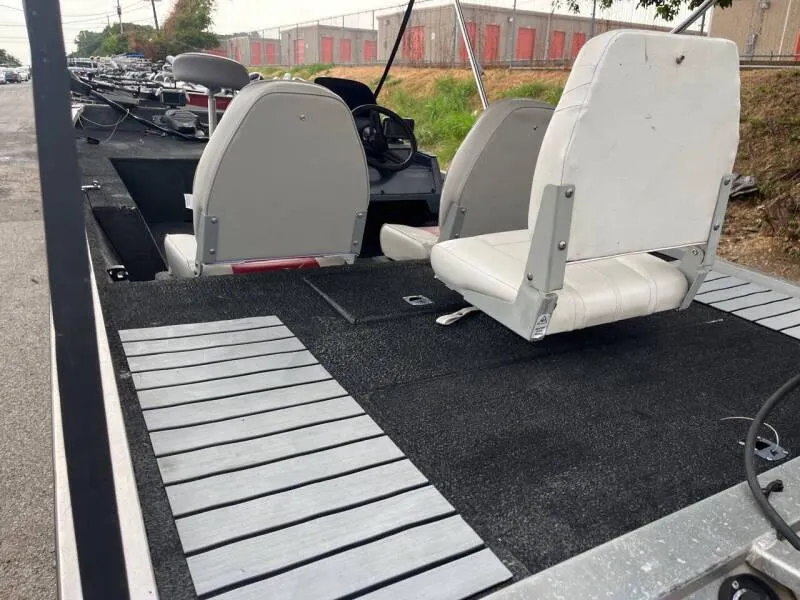 Slide: The Image of 1990 Bass Tracker Pro 17 fishing boat interior with seating and deck. - 17