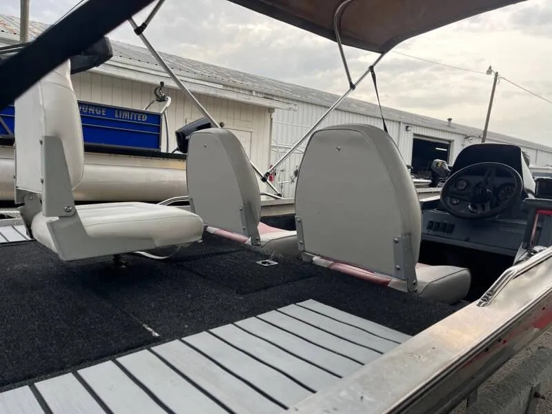 Slide: The Image of 1990 Bass Tracker Pro 17 boat interior with seating and steering console. - 18