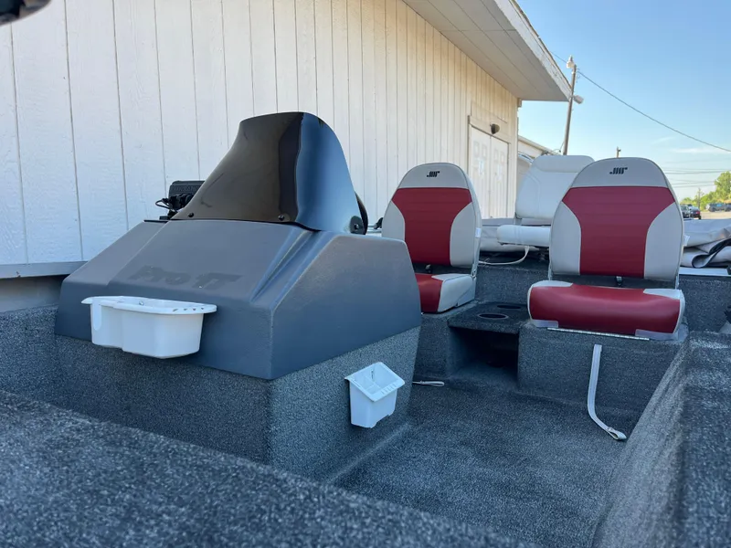 Slide: The Image of 1990 Bass Tracker Pro 17 boat interior with red and gray seats. - 22