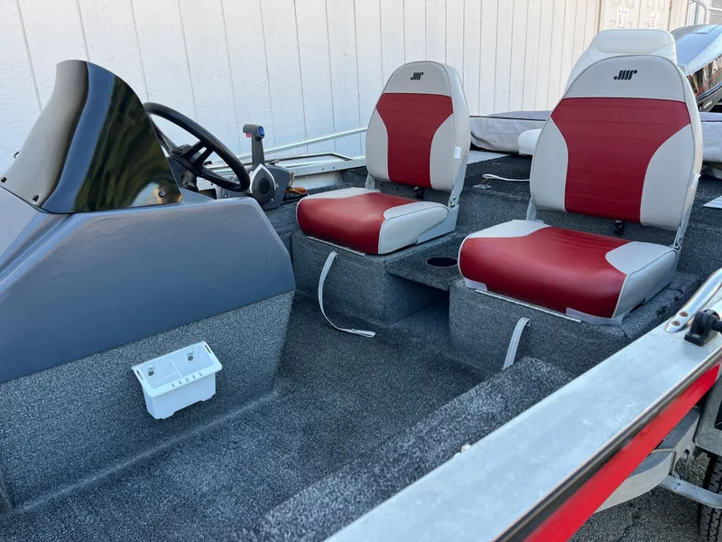 Slide: The Image of 1990 Bass Tracker Pro 17 boat interior with red and white seats. - 23
