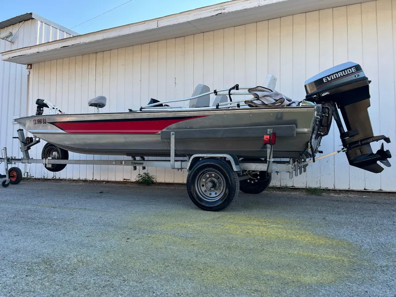 Slide: The Image of 1990 Bass Tracker Pro 17 fishing boat on trailer with Evinrude outboard motor. - 24