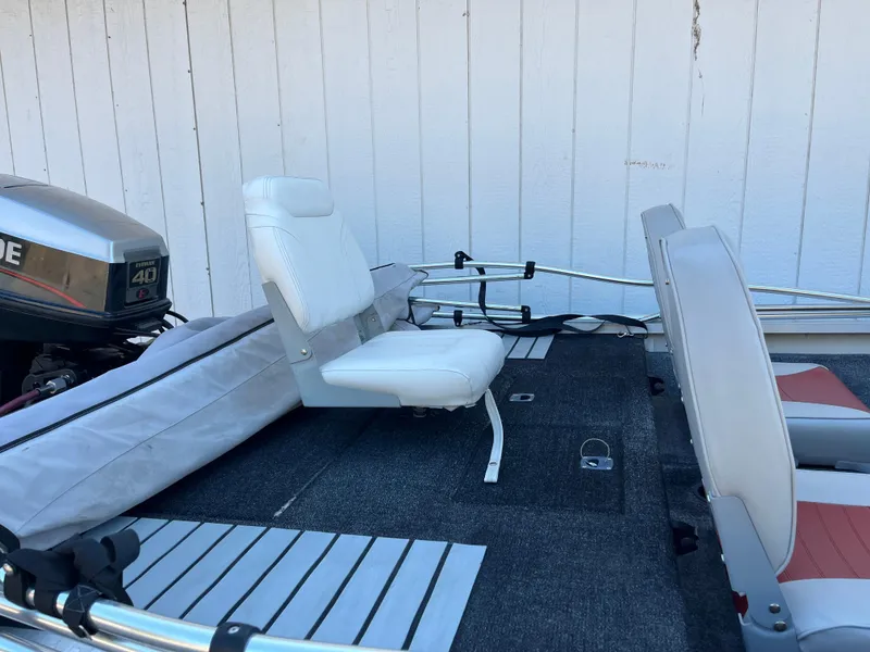 Slide: The Image of 1990 Bass Tracker Pro 17 boat interior with seating and motor. - 28