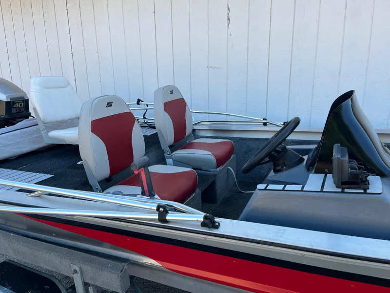 Slide: The Image of 1990 Bass Tracker Pro 17 boat interior with red and white seats. - 30