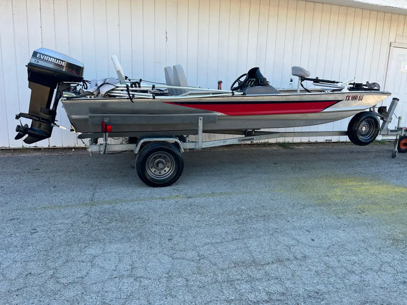 Slide: The Image of 1990 Bass Tracker Pro 17 fishing boat on trailer with Evinrude outboard motor. - 33