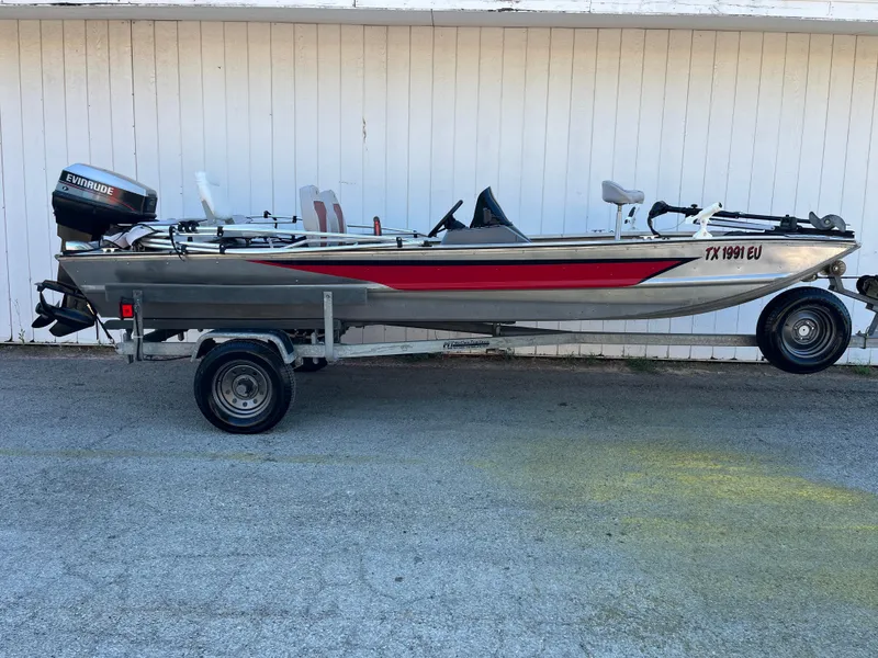 Slide: The Image of 1990 Bass Tracker Pro 17 fishing boat on trailer with Evinrude outboard motor. - 34