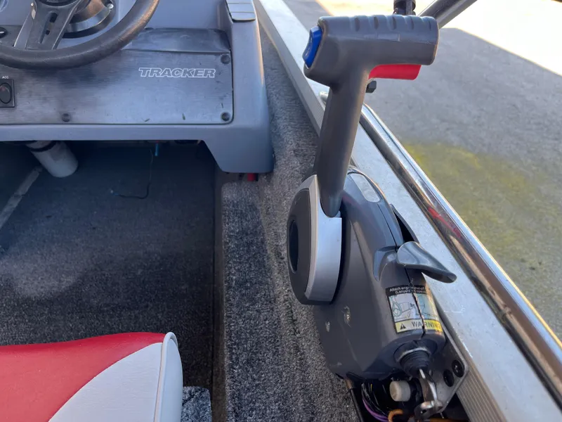 Slide: The Image of 1990 Bass Tracker Pro 17 boat interior with steering wheel and throttle control. - 40