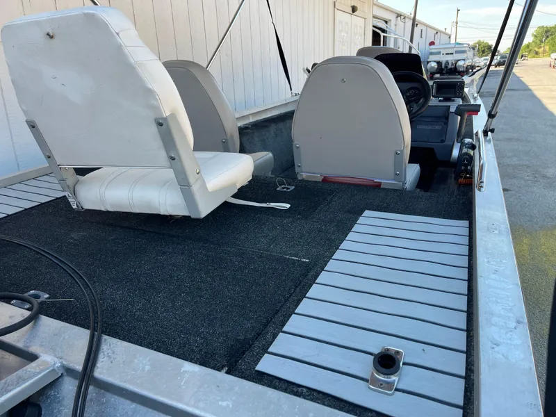 Slide: The Image of 1990 Bass Tracker Pro 17 boat interior with seating and deck. - 47