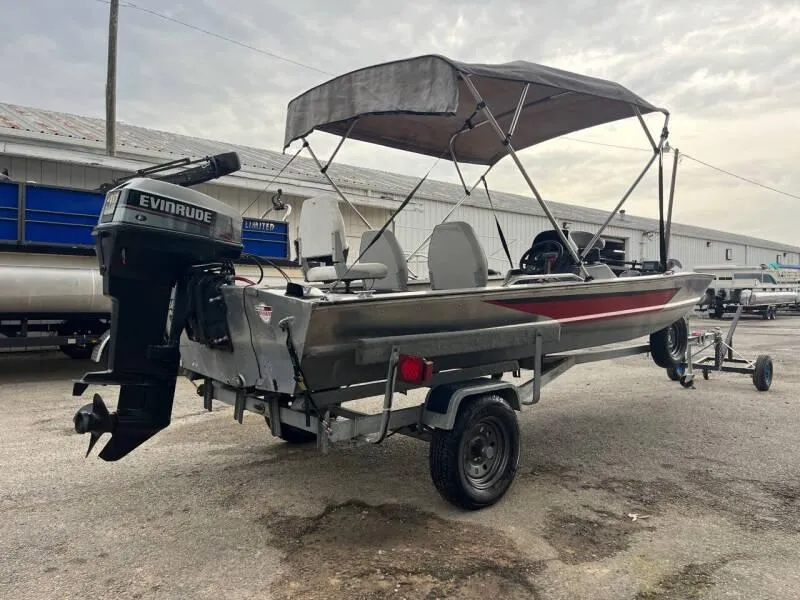 Slide: The Image of 1990 Bass Tracker Pro 17 boat with Evinrude motor on trailer. - 5
